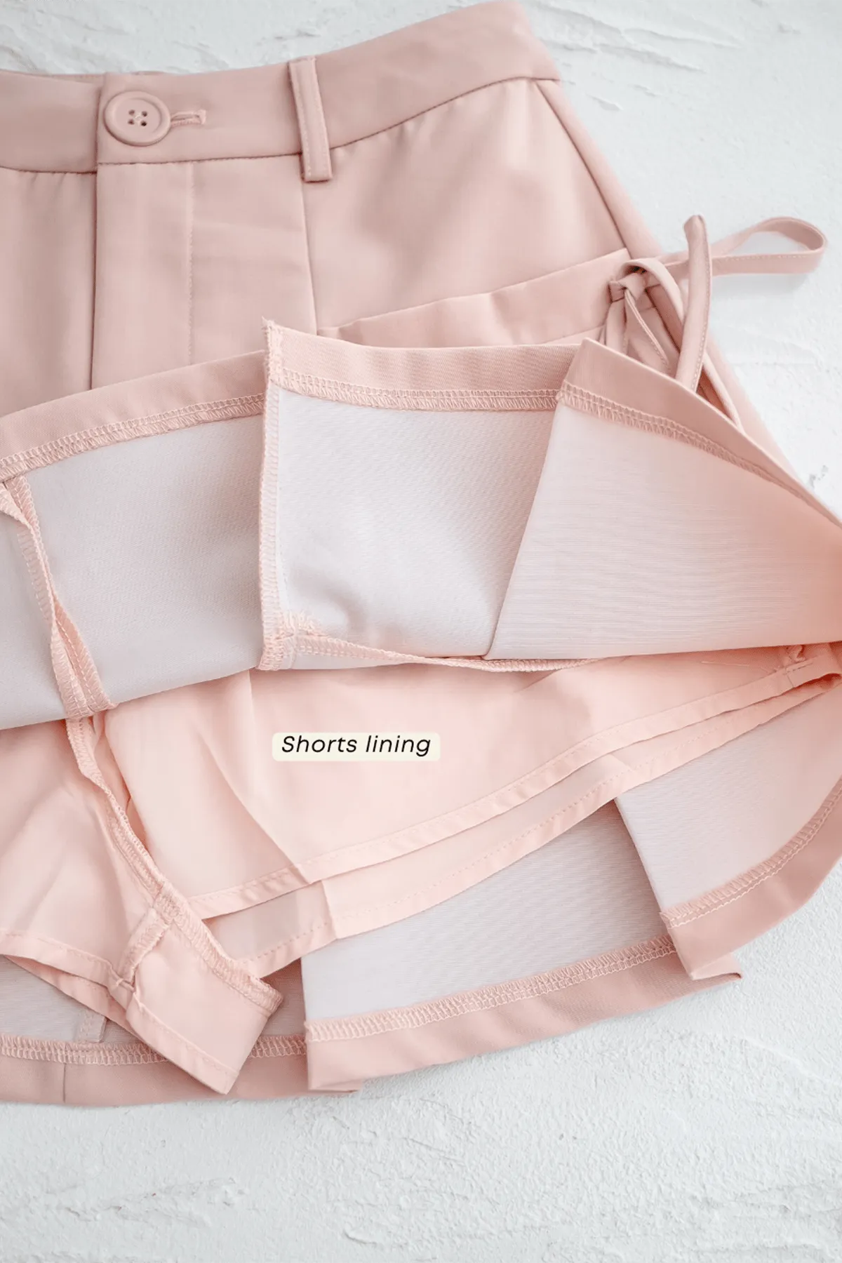 CLARE PLEATED TIE-KNOT SKORTS IN LATTE